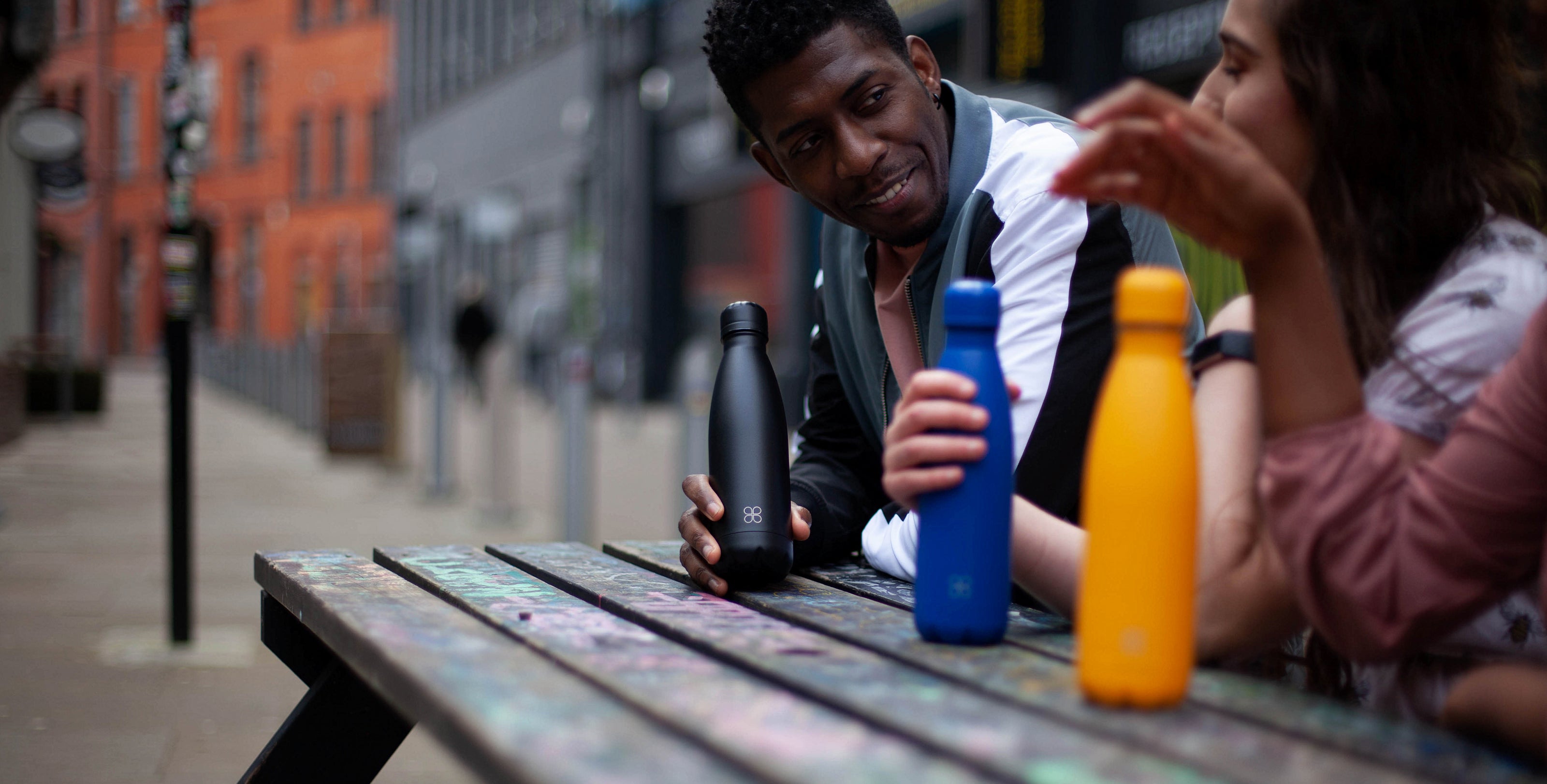 Group of friend enjoying a chat with their new water bottles in Birmingham's art district
