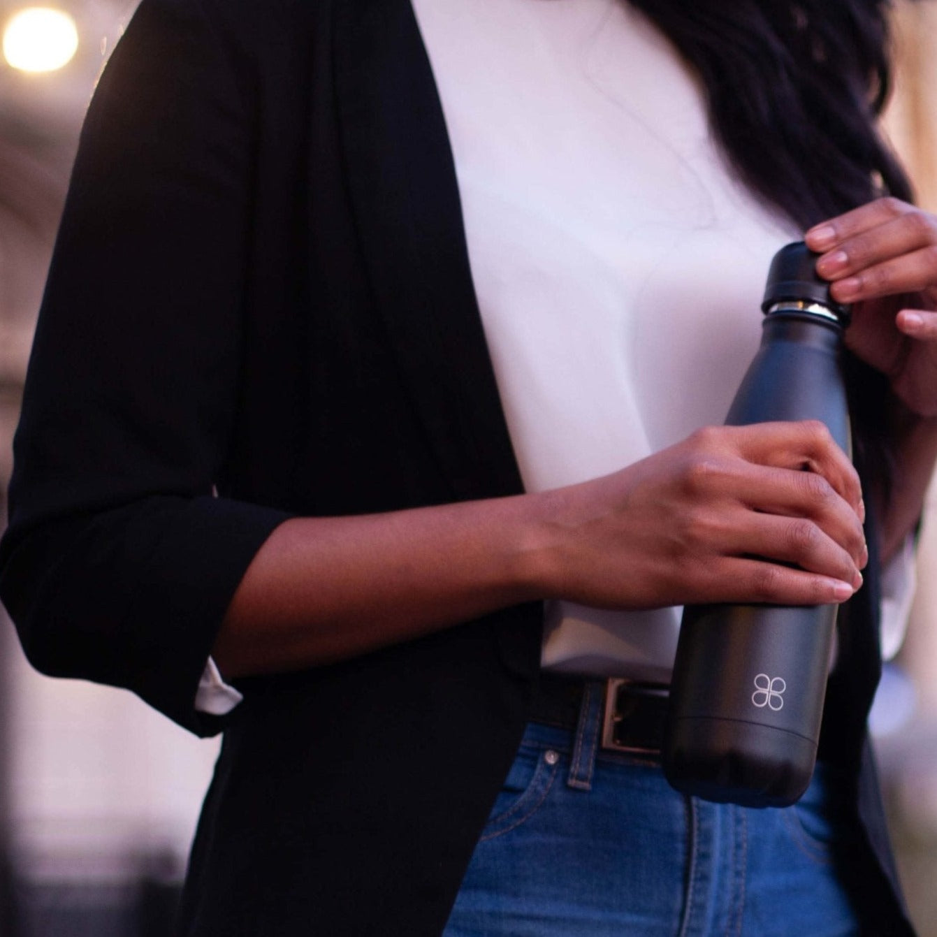 Lady in blazer holding a black water bottle