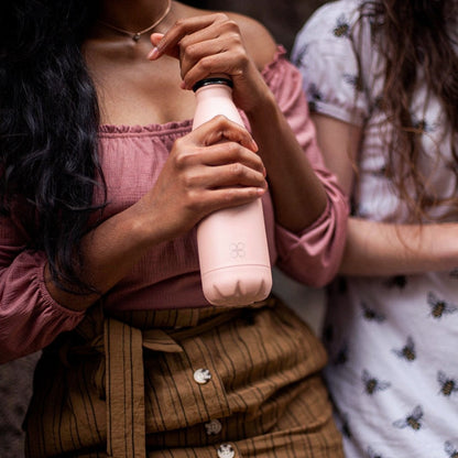 Lady in Rose top holds a Sienna Rose Colour Water Bottle